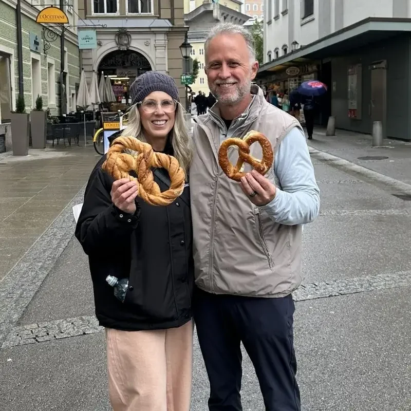 Rick and Clancy Denton holding German pretzels - Empty Nest travel